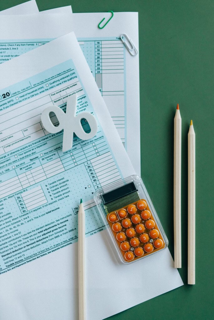 Could You Be Owed a Refund? What the Kwong v. United States Case Means for You 3 flat lay of tax documents, calculator, and pencils on green surface.